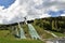 National Ski jumping venue of Switzerland in Eschbach, Einsiedeln surrounded by green forest under blue sky during summer time.