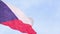 The national state flag of the Czech Republic waving in the wind on a flagpole against the blue sky