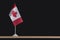 National table flag of Canada on black background. flag with maple leaf