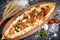 The national Turkish pizza is called pide, next to vegetables and spikelets of wheat
