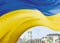 The national Ukrainian flag is superimposed on a background of blue and yellow colors. Ukraine's Independence Day.