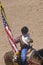 Native American with American Flag at opening ceremony of Inter-Tribal Indian Rodeo, Gallup, NM