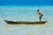 Native boy paddling a canoe made from a hollowed out log, Solomon Islands