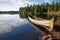 native canoe docked on the serene lake shore