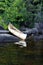 A native canoe sitting on rocks