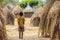 Native child boy thatched huts. Generate Ai