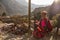 native elderly woman in the highlands of Peru wearing traditional clothes selling goods