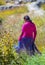 Native Indigenous girl walk on grassland in traditional colorful dress, Mexico, America