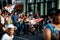 Native people carry group flags in hands walking by city street at dominican carnival