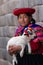 Native Peruvian holding a baby lamb