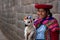 Native Peruvian holding a baby lamb