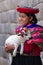 Native Peruvian holding a baby lamb