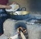 Native Peruvian woman preparing Cachangas aka fried bread on a p