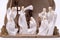 A nativity set depicting the three wise men visiting Jesus set against a clean white background