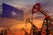 NATO oil industry concept. Industrial illustration - NATO flag and oil wells with the red and blue sunset or sunrise sky