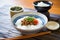 natto atop a bed of steamed white rice in a bowl