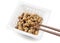 Natto packets and chopsticks on a white background