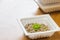 Natto - a popular and healthy Japanese food from fermented beans in a Styrofoam container with green spring onions as toppings.
