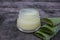 Natural aloe vera face cream on dark vintage wooden background. Homemade beauty product.