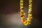 Natural amber beads shining on sun close up. Handmade souvenir of real gems on a dark background, selective focus