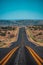 Natural american landscape with asphalt way to horizon. Panoramic picture of a scenic road, USA. Endless straight, Route