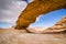 Natural arch in desert with sandstone and granite rock Wadi Rum in Jordan