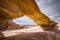 Natural arch in desert with sandstone and granite rock Wadi Rum in Jordan