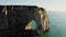 A natural arch in a limestone sheer cliff, washed by sea waters