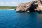 Natural arch and recreational boat at Cala Antena