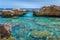 Natural arch in a rocky cliff in the National Park of the Gulf of Orosei, Sardinia, Italy.