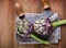 Natural artichokes on a rustic wooden table close up