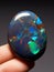 Natural Australian precious black matrix opal. Multi color flashes cabochon polished gemstone setting for jewelry making