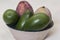 Natural avocados and mangoes on white background