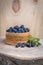 Natural background.Blueberry berries in a birch box on birch stump .Wooden background