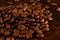 Natural background for Cafe menu or brochure template - macro photo of brown roasted coffee beans, close up