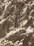 Natural background. Closeup edged shabby cliff cracks. Gray-brown stone rock texture of mountains. Vintage and faded