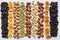 Natural background made from different kinds of nuts. Assortment of nuts in bowls