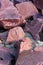 Natural background with red chipped stones. Red crushed stone on the ground close-up .