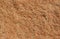 Natural background of unpolished red-orange Sandstone with black and white specks