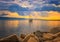 Natural background with Yacht in the Mediterranean sea at sunrise, Cagliari, Italy. he sun illuminates the island with beautiful