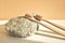 Natural bamboo toothbrush on a white background with a decor of natural stone and flowers. Plastic free Essentials, dental care.