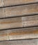 Natural bamboo trunk dry weathered, part of a wooden construction stacked of round trunks background