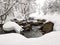 Natural barrage in stream in special view in winter scenery covered in deep snow