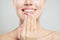 Natural beauty concept. Closeup female smile with natural pink lips and french manicure hand