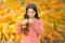 Natural beauty. Small girl wear autumn leaves in natural hair. Little child on natural landscape. Idyllic autumn nature