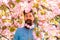 Natural beauty surrounds me. Handsome bearded man outdoors. Happy easter. Hipster in cherry bloom. Man in sakura blossom