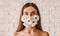 Natural beauty of young attractive woman in flower medical face mask