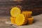 Natural beeswax cake blocks on wooden table, closeup