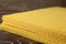 Natural beeswax sheets on wooden table, closeup