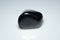 natural black shungite cabochon on the background